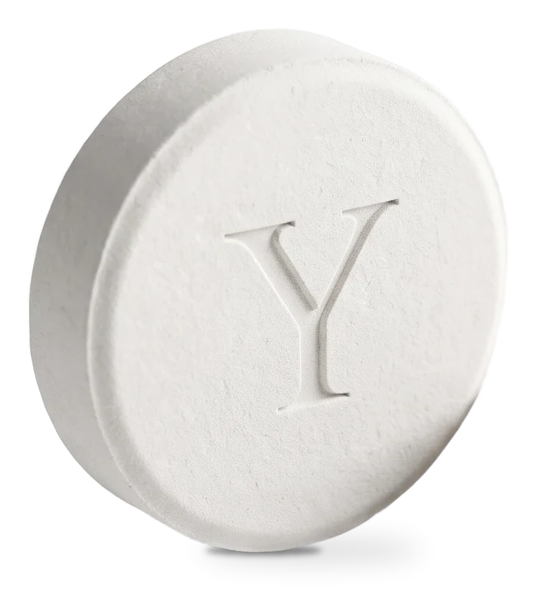 A white YUAMI shower tablet stamped with a Y
